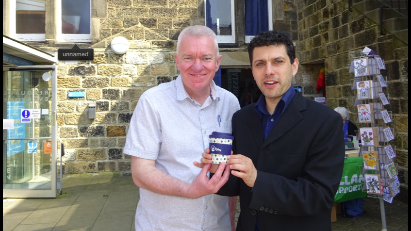 Otley Green Fair 2019. Alex Sobel MP and Ray Georgsson Leader of the Otley Council holding reusable coffee mugs at the Green Fair 2018. 